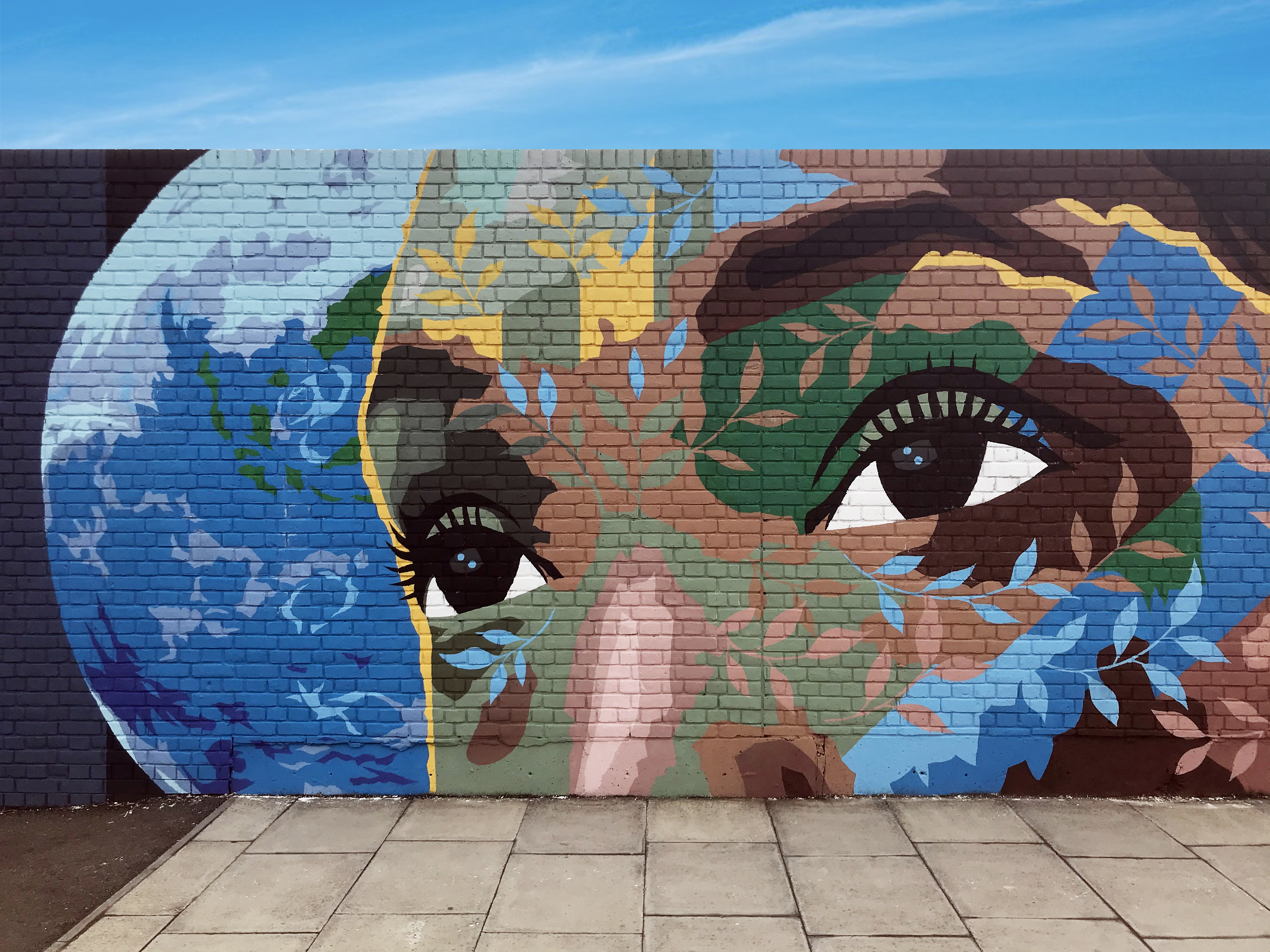 A person's face painted on a wall.